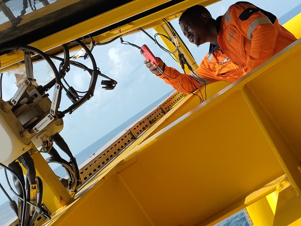 Supanova technician testing electrical connections during installation of a solar power system for an SPM